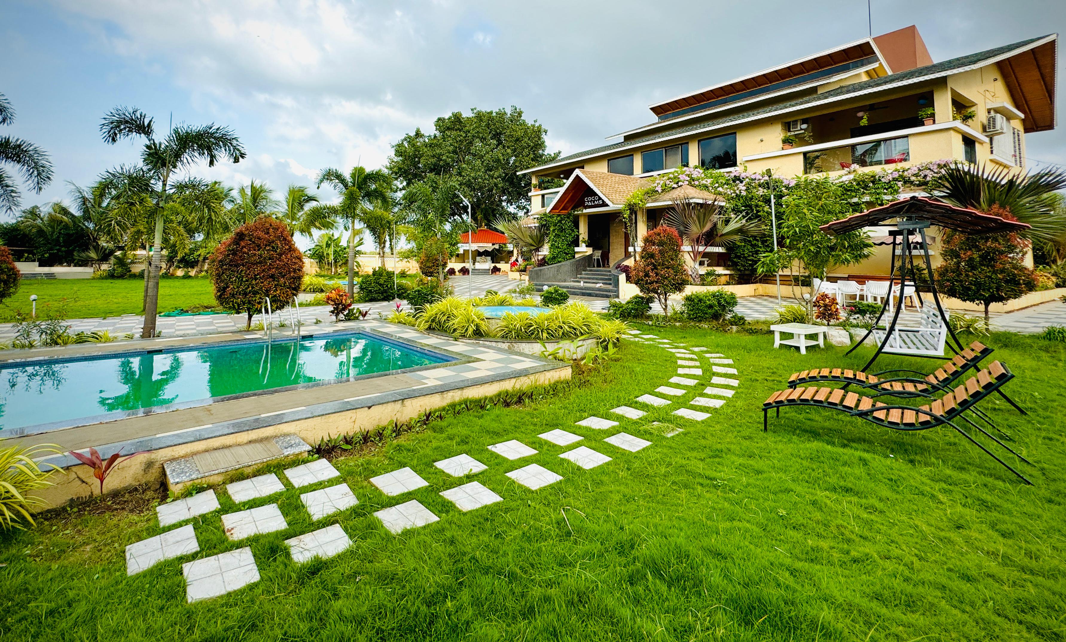 Coco Palms Villa exterior with pool and lush lawns